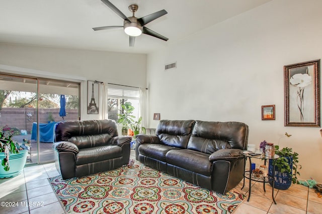 tiled living room featuring vaulted ceiling and ceiling fan