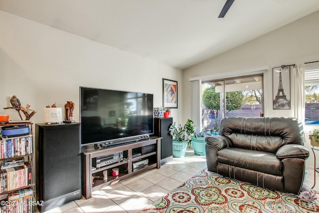 tiled living room with ceiling fan and vaulted ceiling