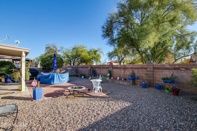 view of yard featuring a patio and a fire pit