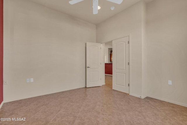 tiled empty room with ceiling fan