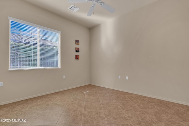 spare room featuring ceiling fan and light tile patterned floors