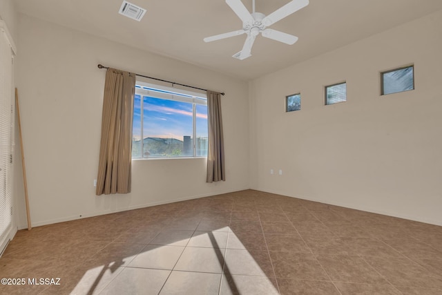 tiled empty room with ceiling fan