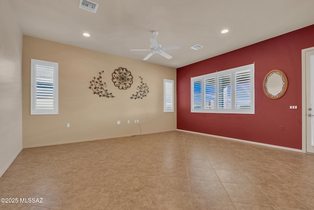 unfurnished room with a wealth of natural light and ceiling fan