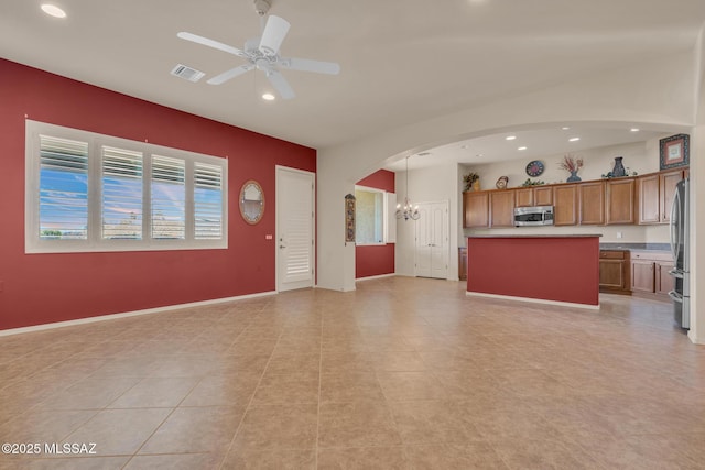 unfurnished living room with light tile patterned floors and ceiling fan with notable chandelier