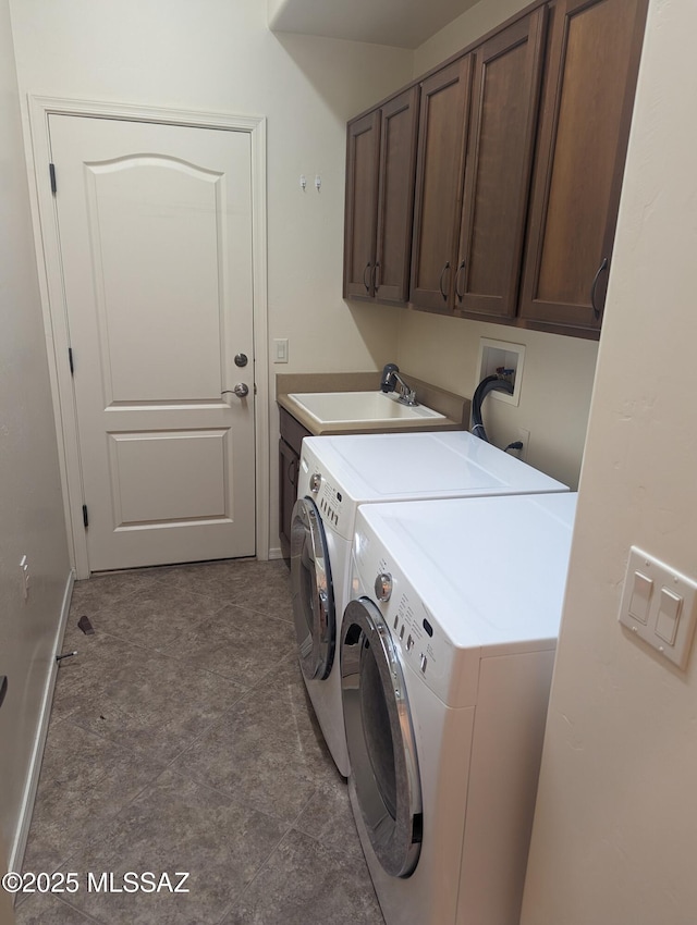 laundry room with sink, cabinets, and independent washer and dryer