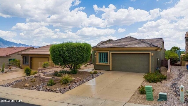 view of front of house featuring a mountain view and a garage