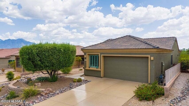 view of front facade featuring a mountain view and a garage