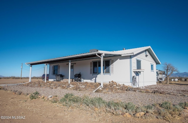 back of house with metal roof
