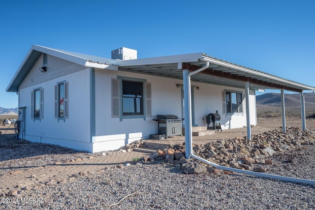 back of house featuring a mountain view