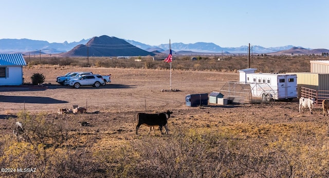 view of yard featuring a mountain view, an outbuilding, and exterior structure