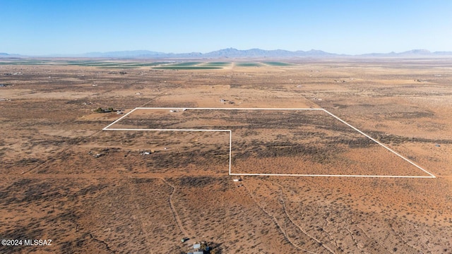 birds eye view of property with view of desert and a mountain view