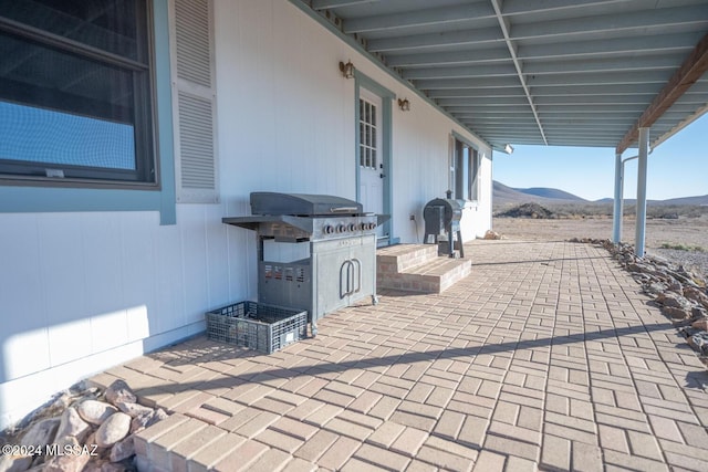 view of patio / terrace featuring a mountain view and grilling area