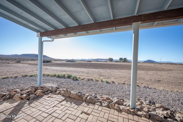 view of patio with a mountain view and a rural view