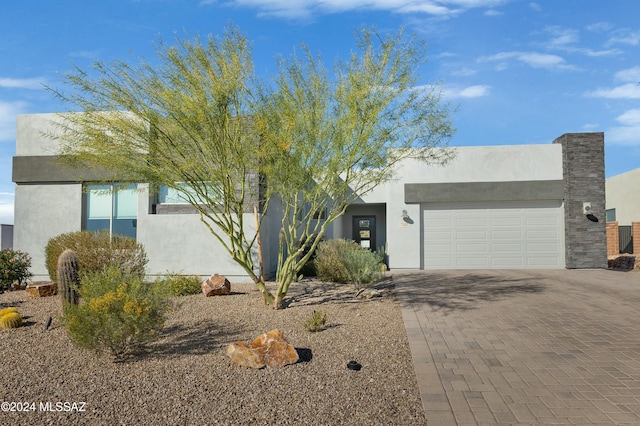 pueblo-style house featuring a garage