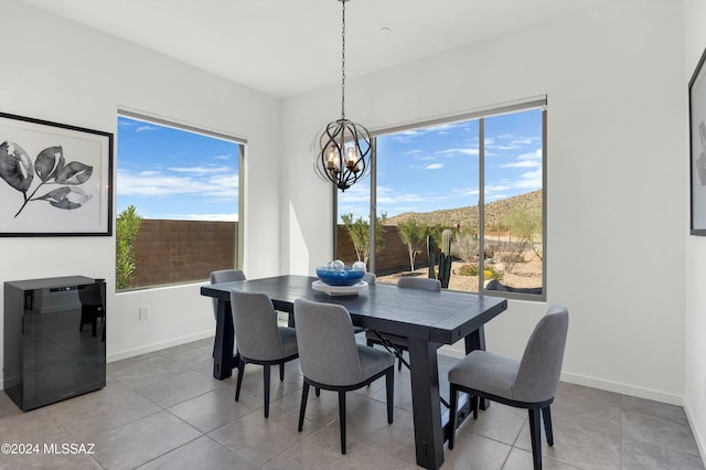 dining area with a chandelier, wine cooler, and light tile patterned flooring