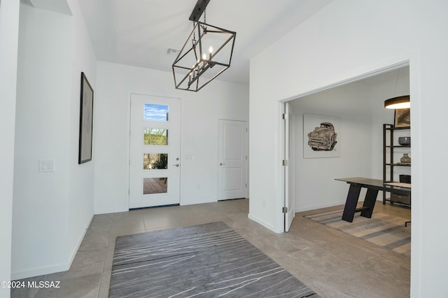 foyer entrance featuring baseboards, a notable chandelier, tile patterned flooring, and visible vents