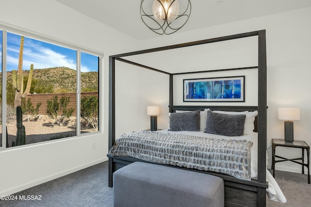 carpeted bedroom with a chandelier