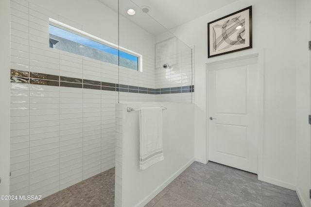 bathroom with tile patterned floors and tiled shower