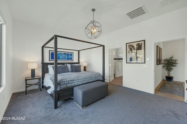 bedroom featuring ensuite bathroom, visible vents, and carpet