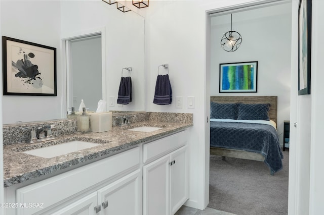 bathroom featuring ensuite bathroom, a sink, and double vanity