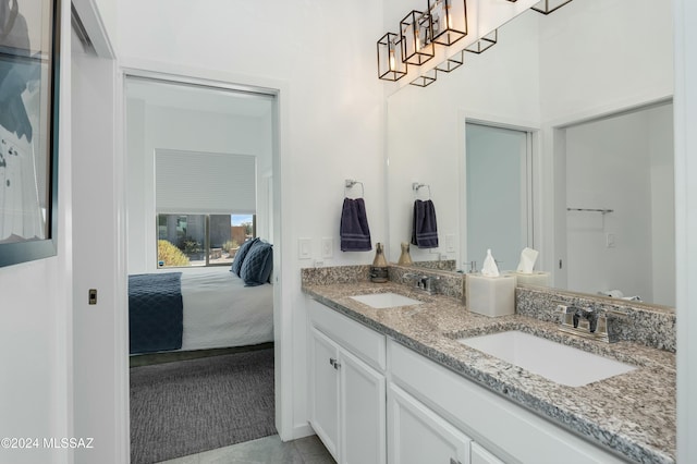 full bath with tile patterned flooring, ensuite bath, a sink, and double vanity