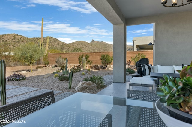 view of patio / terrace featuring a fenced backyard, outdoor lounge area, and a mountain view