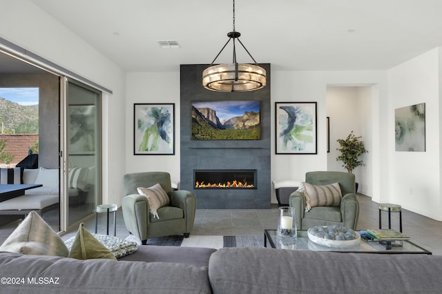 living room with a fireplace and a chandelier