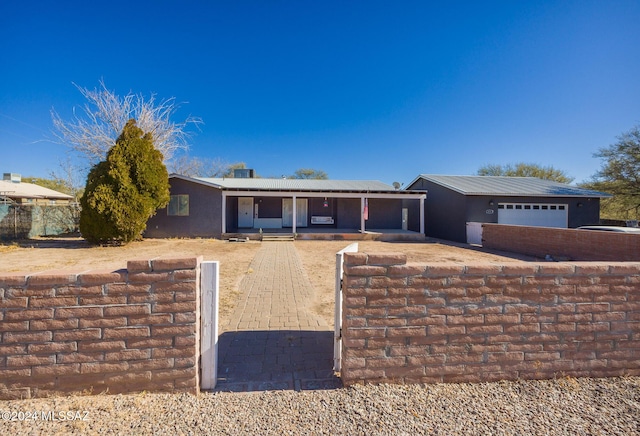 view of front of property featuring covered porch and a garage