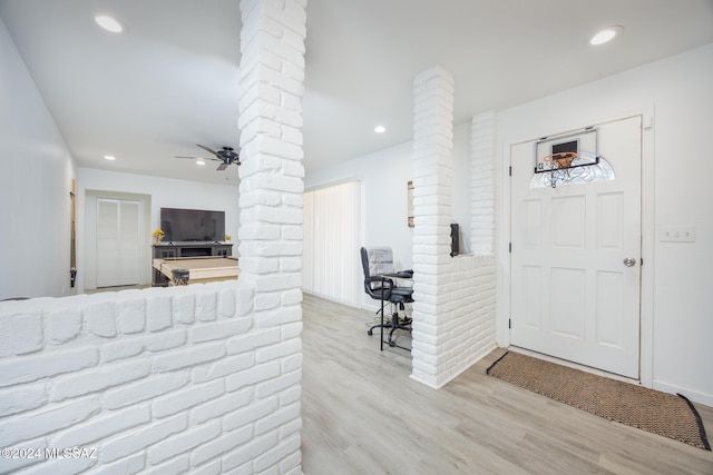 foyer with ceiling fan, light wood-type flooring, and decorative columns