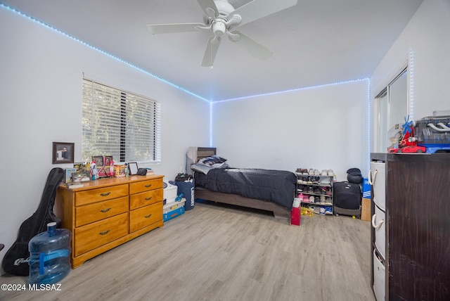 bedroom with ceiling fan and light hardwood / wood-style flooring