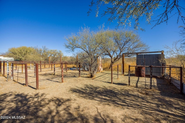 view of yard featuring a rural view and an outdoor structure