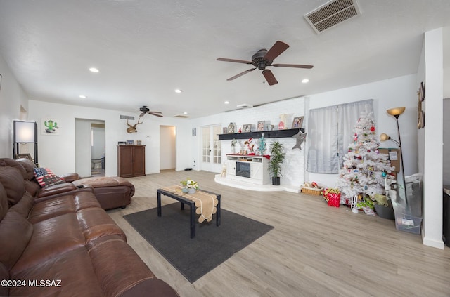 living room featuring light hardwood / wood-style floors and ceiling fan