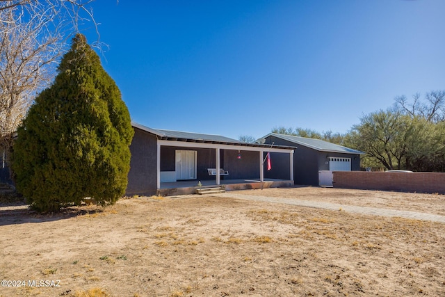 single story home with a porch and a garage