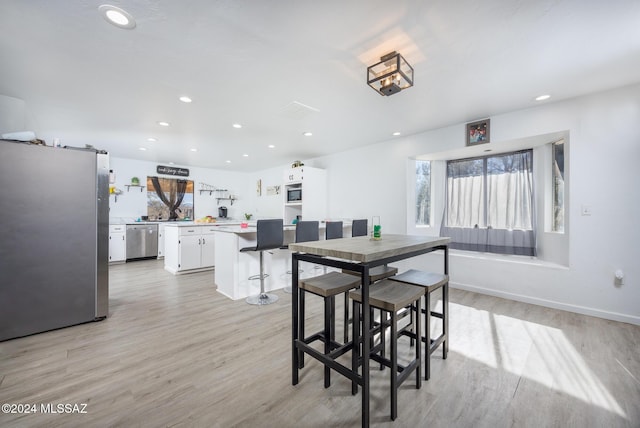 dining area featuring light wood-type flooring