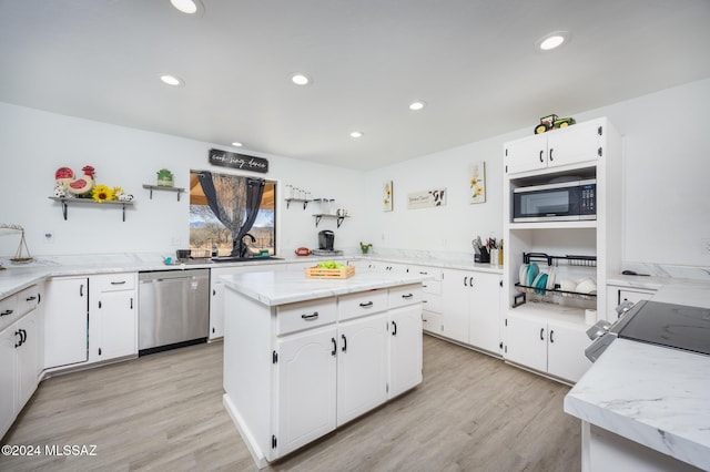 kitchen featuring dishwasher, white cabinets, a kitchen island, and built in microwave