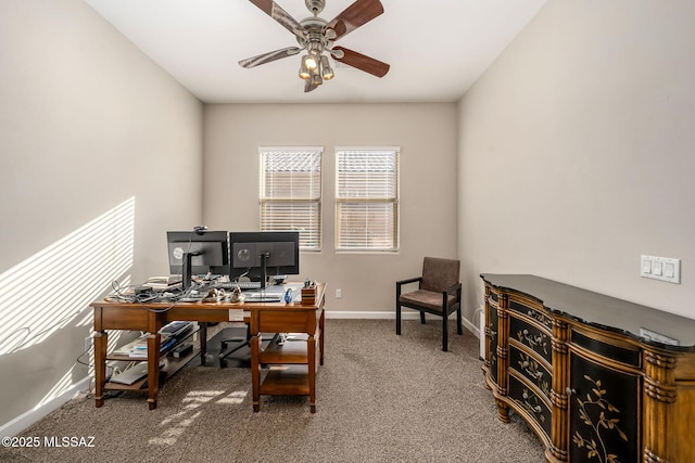 carpeted office space featuring ceiling fan