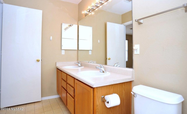 bathroom featuring tile patterned floors, vanity, and toilet