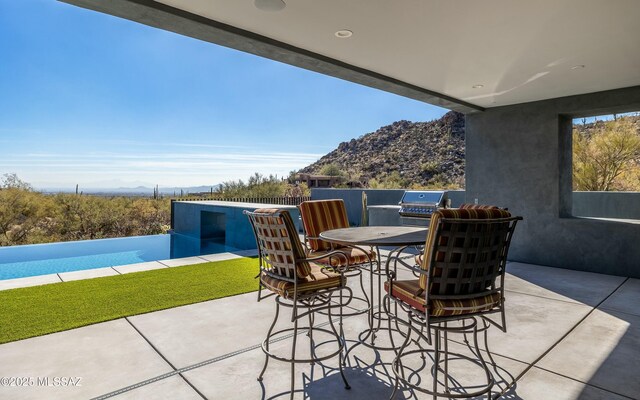 view of patio featuring grilling area and a mountain view