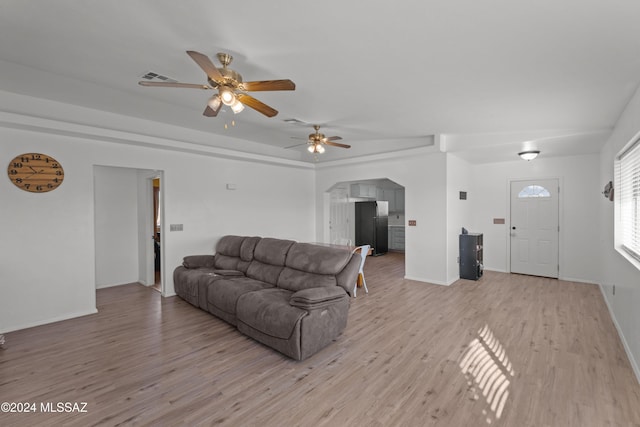 living room with ceiling fan and light wood-type flooring