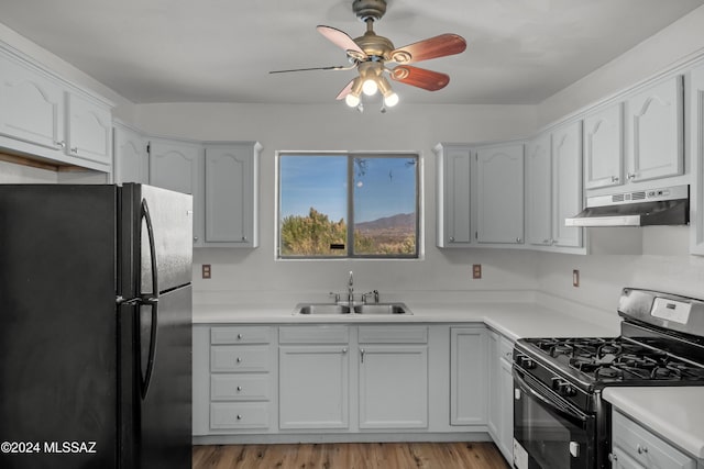 kitchen with white cabinetry, sink, ceiling fan, light hardwood / wood-style flooring, and black appliances