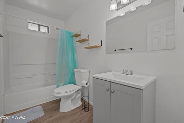 full bathroom with toilet, wood-type flooring, vanity, and shower / tub combo with curtain