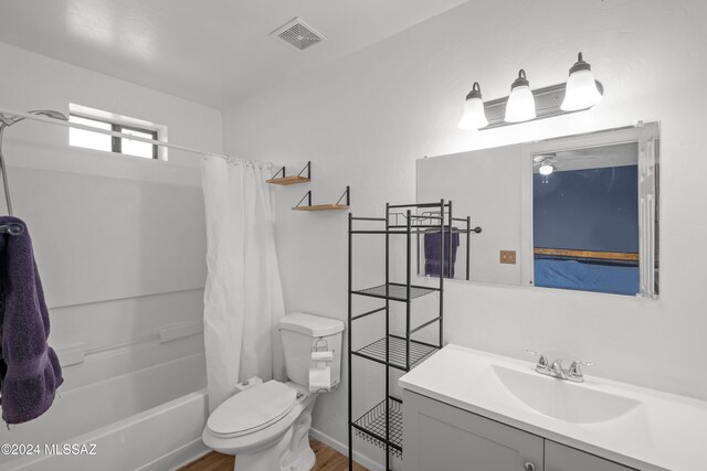 full bathroom featuring wood-type flooring, vanity, toilet, and shower / bathtub combination with curtain