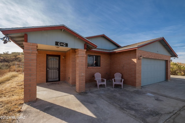 view of front of property with a patio and a garage