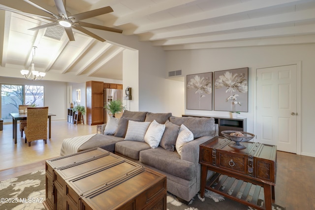 living room with vaulted ceiling with beams and ceiling fan with notable chandelier