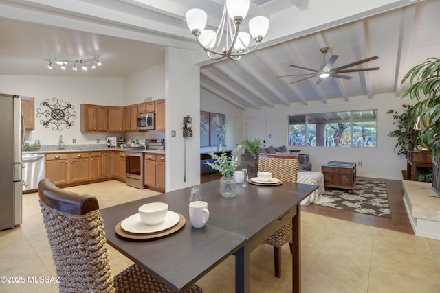 tiled dining area with beam ceiling, ceiling fan with notable chandelier, high vaulted ceiling, and sink