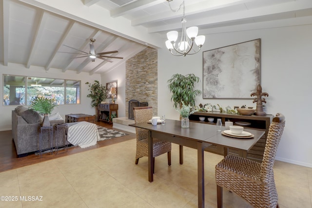 dining area featuring tile patterned flooring, lofted ceiling with beams, and ceiling fan with notable chandelier