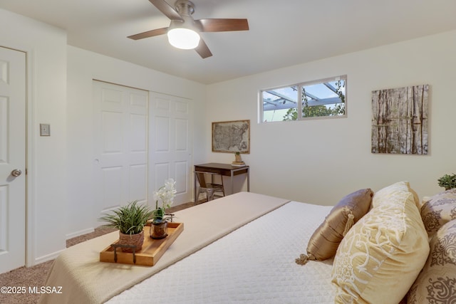 carpeted bedroom featuring ceiling fan and a closet