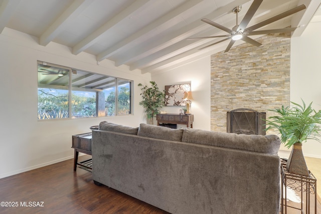 living room with lofted ceiling with beams, a large fireplace, dark hardwood / wood-style floors, and ceiling fan