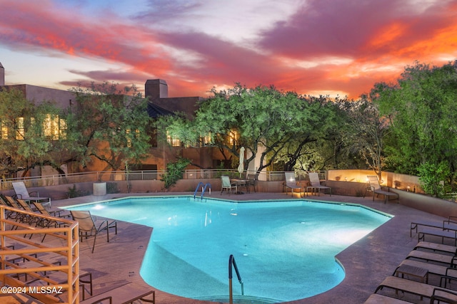 view of pool at dusk