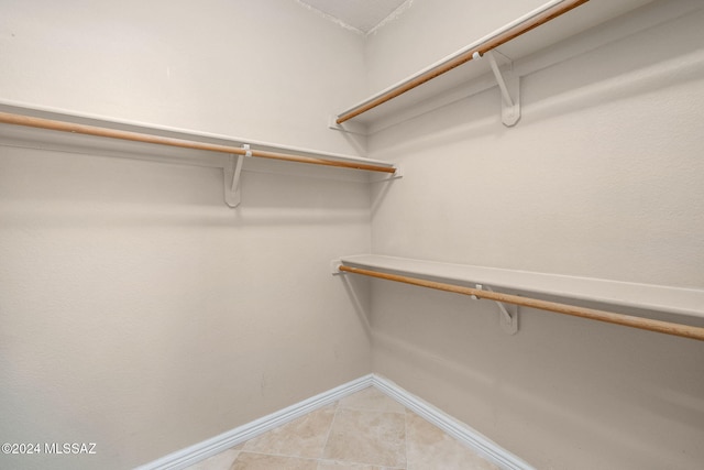 spacious closet featuring light tile patterned flooring